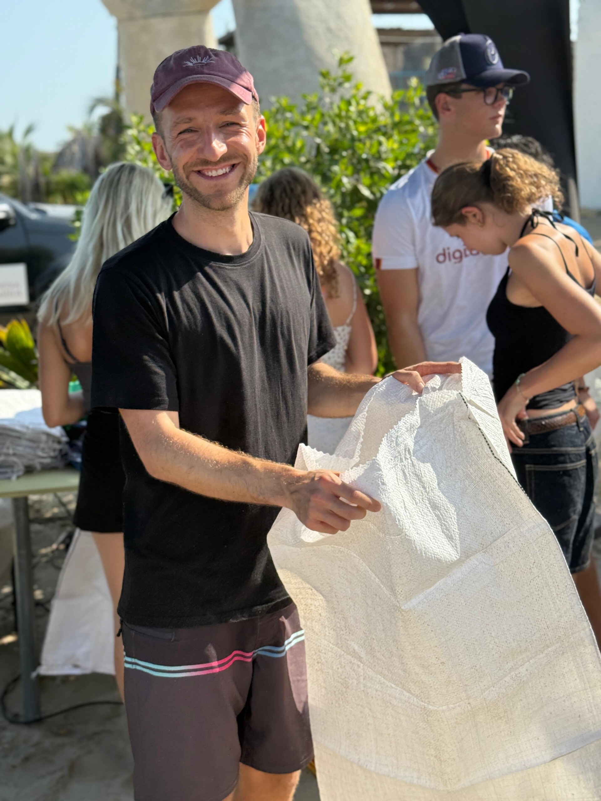 Fynn Hedrich, founder of OceanPulse, preparing cleanup materials during an environmental event