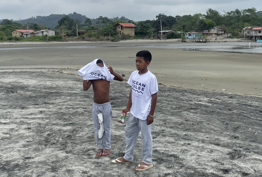 Boys in OceanPulse Shirt while beach clean up