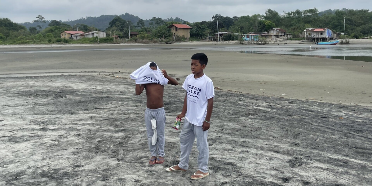 Boys in OceanPulse Shirt while beach clean up