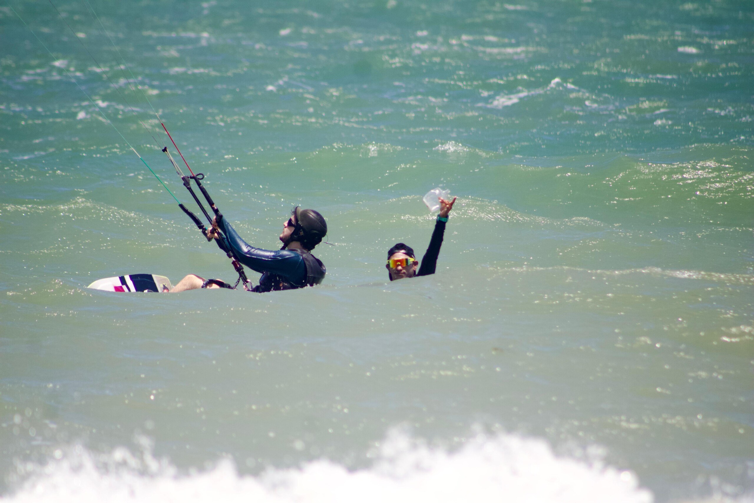 Kite instructor holding up ocean plastic